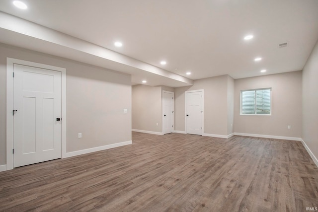 basement with hardwood / wood-style floors