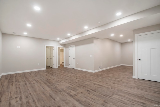 basement with hardwood / wood-style floors