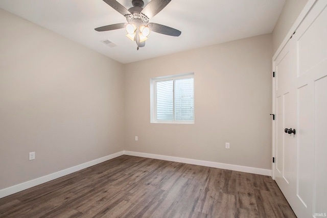 spare room with wood-type flooring and ceiling fan