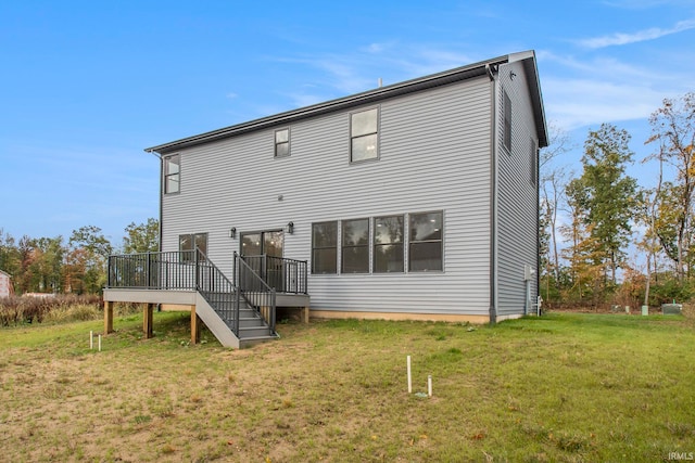 back of house with a yard and a wooden deck