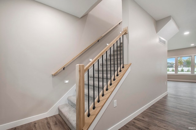 staircase with wood-type flooring