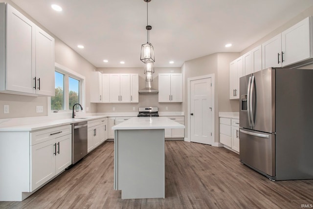 kitchen with appliances with stainless steel finishes, white cabinetry, and a kitchen island