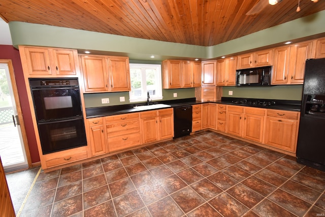 kitchen with black appliances, dark tile patterned flooring, sink, and wooden ceiling