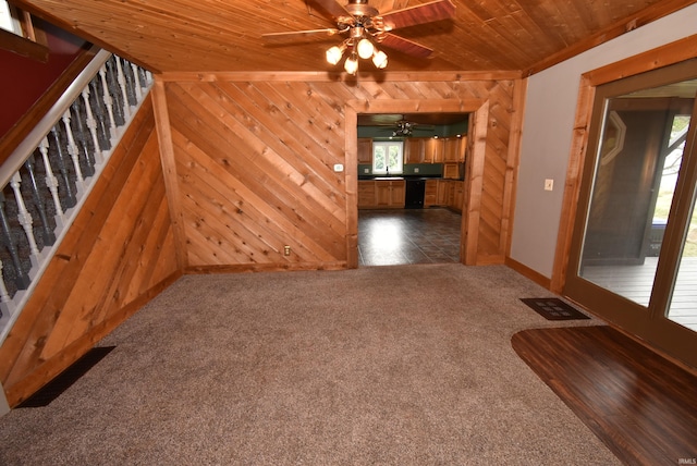 interior space featuring plenty of natural light, wood walls, and wooden ceiling