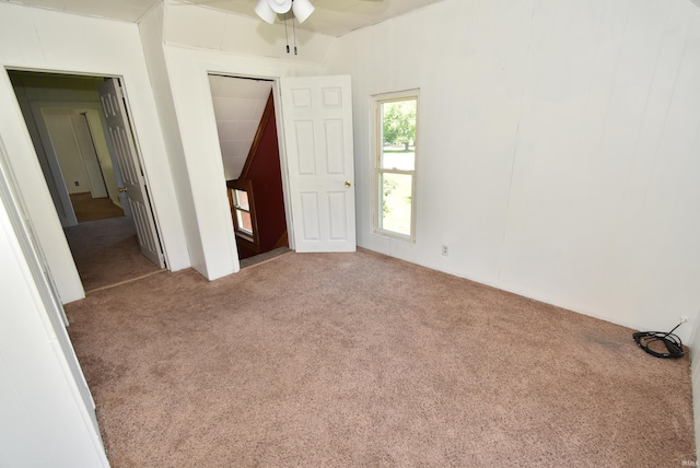 carpeted spare room with ceiling fan