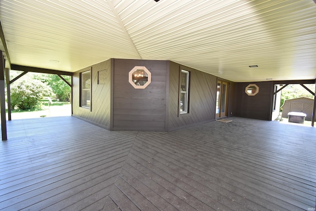 wooden terrace featuring a shed