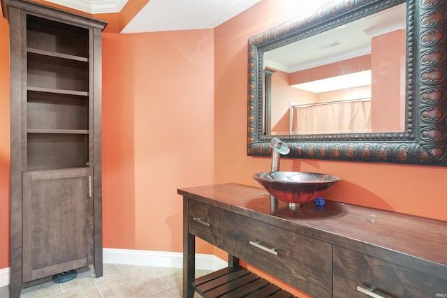 bathroom featuring vanity, crown molding, and tile patterned floors