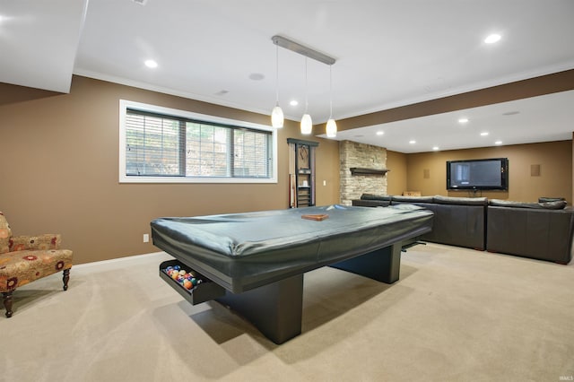 rec room with light carpet, crown molding, pool table, and a stone fireplace