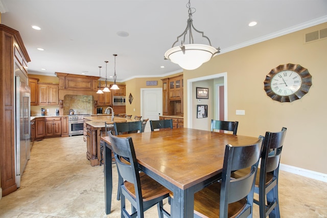 dining room featuring crown molding and sink