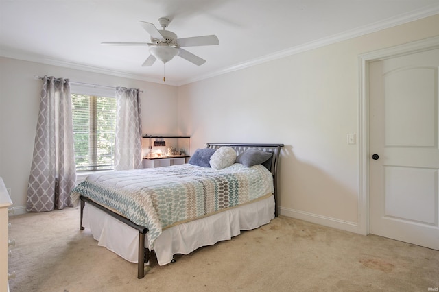 carpeted bedroom with ornamental molding and ceiling fan