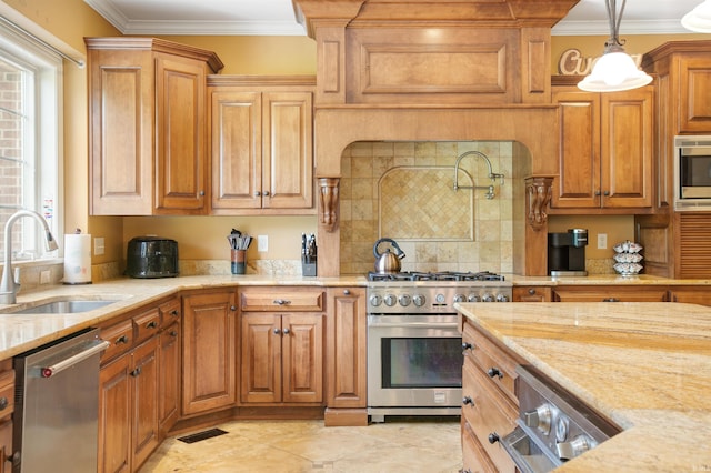 kitchen featuring light stone counters, pendant lighting, ornamental molding, sink, and appliances with stainless steel finishes