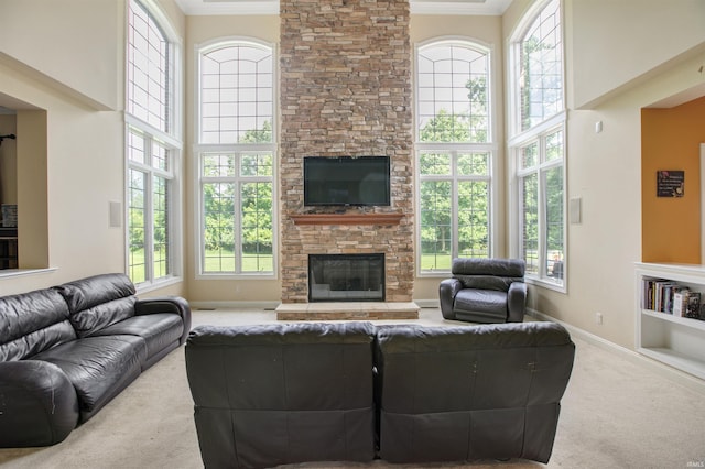 living room with a fireplace, crown molding, a high ceiling, and carpet