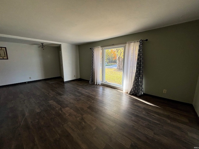 spare room featuring dark wood-type flooring