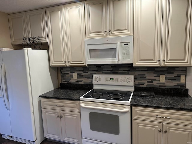 kitchen with decorative backsplash, white appliances, and dark stone counters