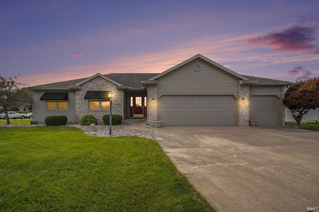 ranch-style house with a yard and a garage