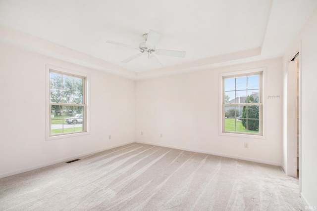 carpeted empty room featuring plenty of natural light and ceiling fan