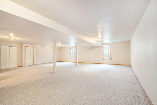 basement featuring light colored carpet