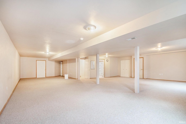 basement featuring light colored carpet