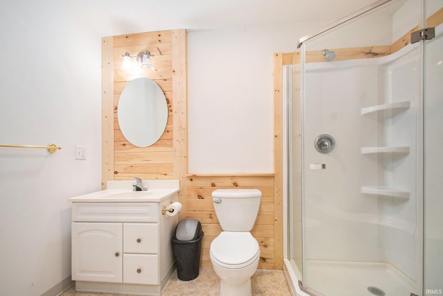 bathroom featuring vanity, walk in shower, toilet, and wooden walls