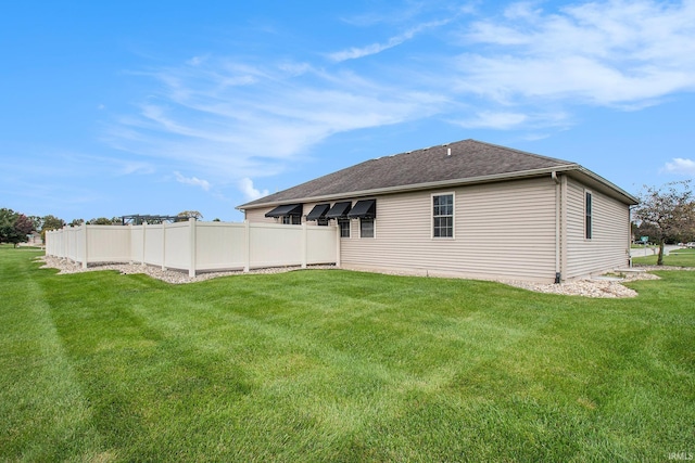 rear view of property with a lawn