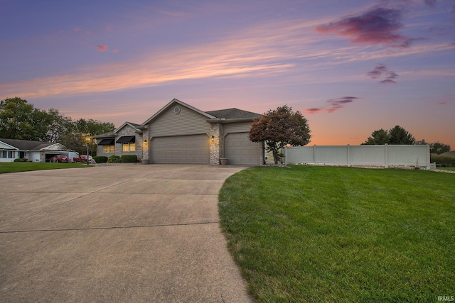 single story home with a garage and a lawn