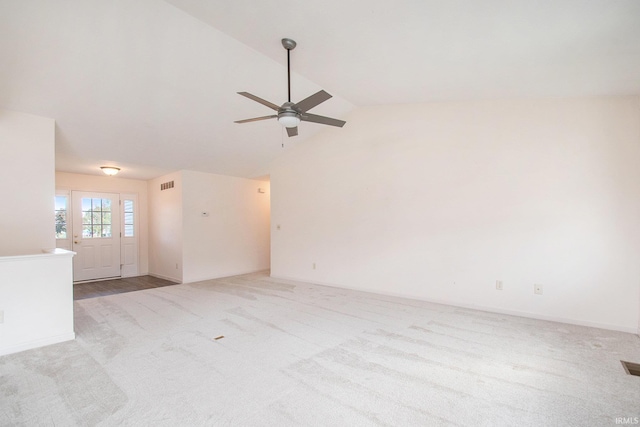 unfurnished room featuring lofted ceiling, light carpet, and ceiling fan