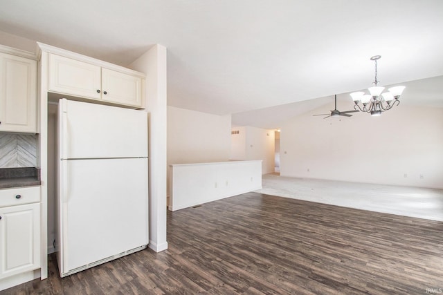 kitchen with white cabinetry, white fridge, ceiling fan with notable chandelier, and dark hardwood / wood-style flooring