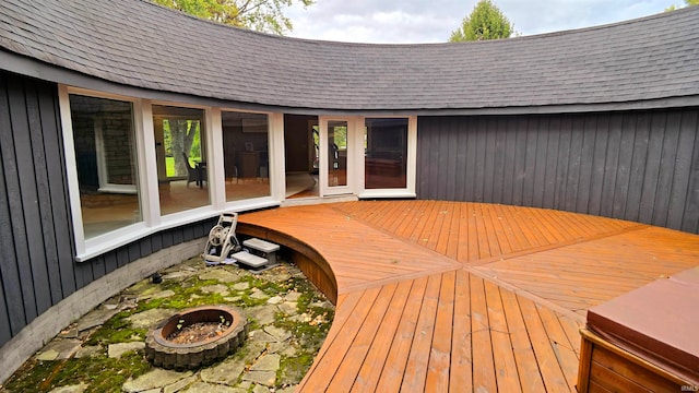 wooden deck with an outdoor fire pit