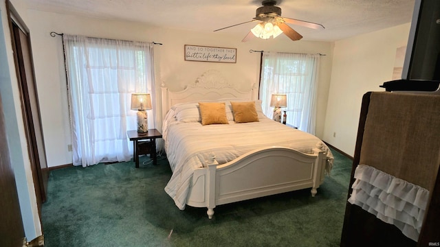 carpeted bedroom featuring ceiling fan and multiple windows