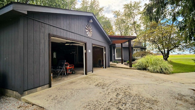 view of side of home with a garage and a lawn