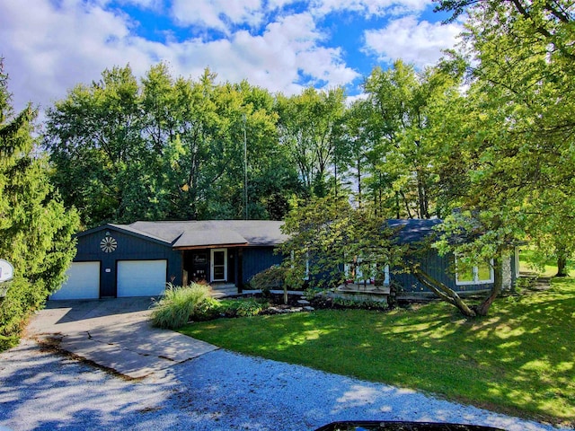 view of front of property with a front lawn and a garage