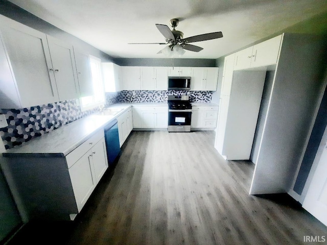 kitchen with backsplash, stainless steel appliances, and white cabinets