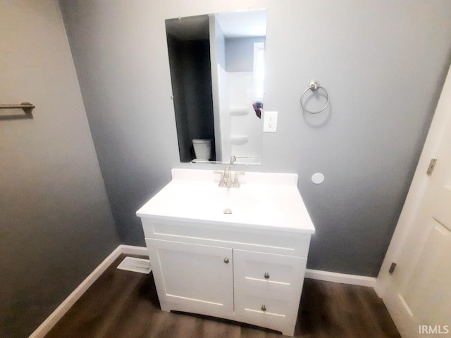 bathroom with vanity, toilet, and wood-type flooring