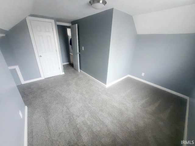 bonus room with carpet flooring and vaulted ceiling