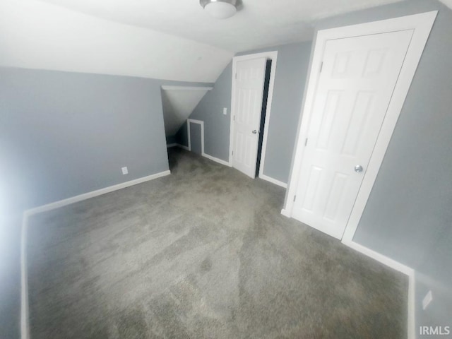 bonus room featuring vaulted ceiling and carpet flooring