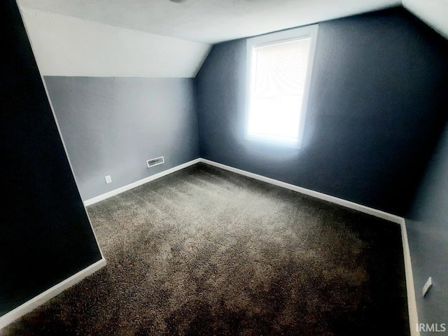 bonus room featuring lofted ceiling and carpet flooring