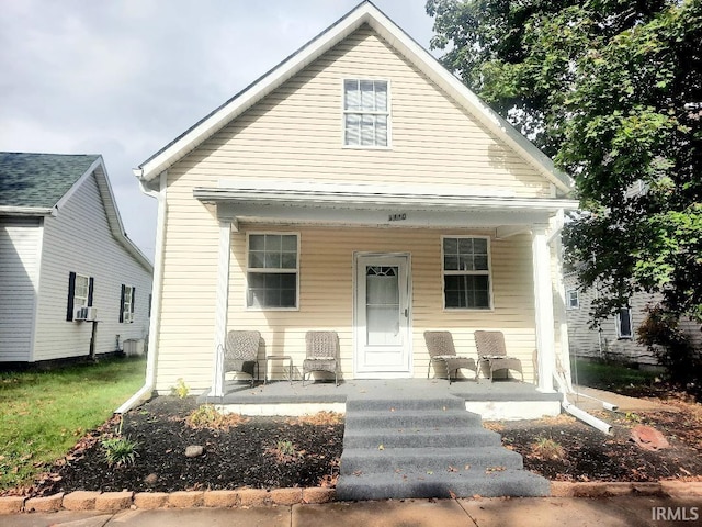 view of front of property featuring cooling unit and a porch