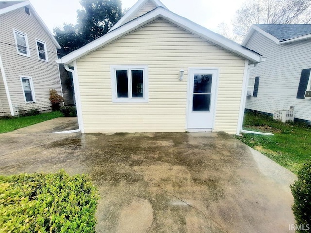 rear view of house with a patio area and cooling unit