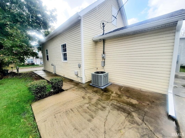 view of property exterior featuring central AC and a patio area