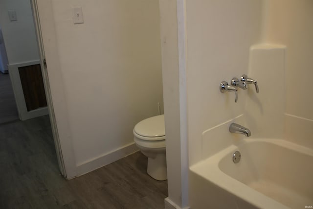 bathroom with hardwood / wood-style flooring and toilet