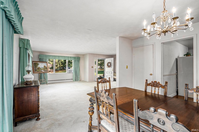 carpeted dining area featuring a baseboard radiator, a textured ceiling, and an inviting chandelier