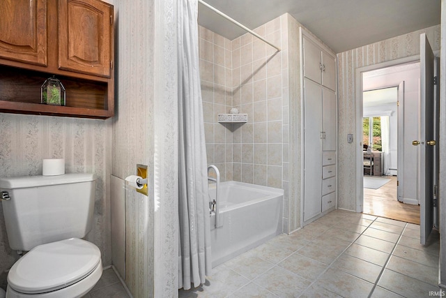 bathroom featuring toilet, shower / tub combo with curtain, and tile patterned floors