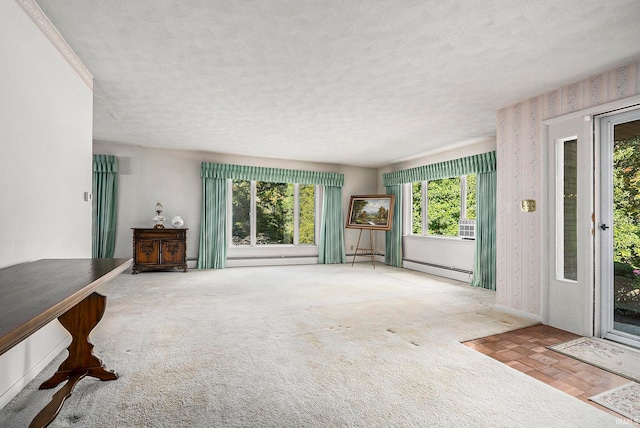 unfurnished living room with a baseboard radiator, a textured ceiling, and light colored carpet