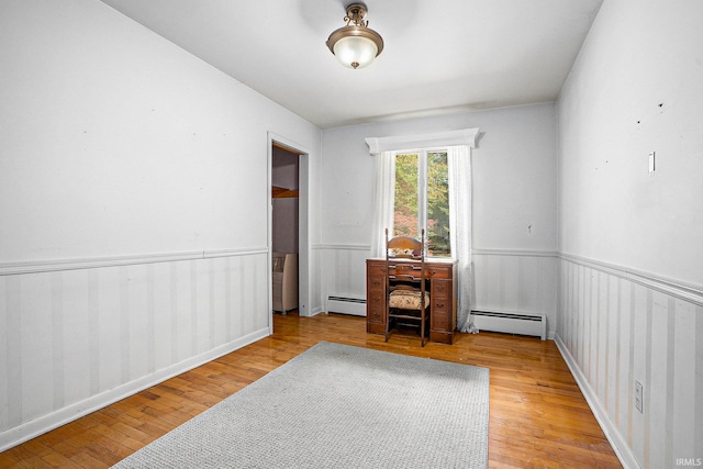 spare room with light hardwood / wood-style floors and baseboard heating