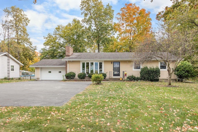 single story home with a garage and a front lawn