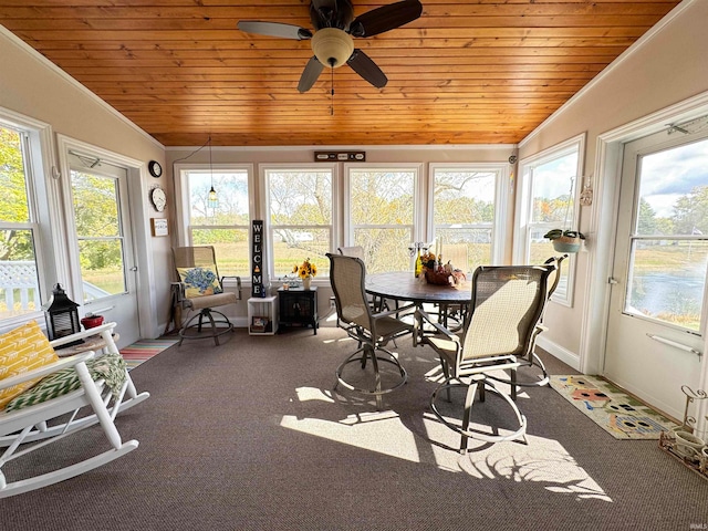 sunroom with vaulted ceiling, a wealth of natural light, and ceiling fan