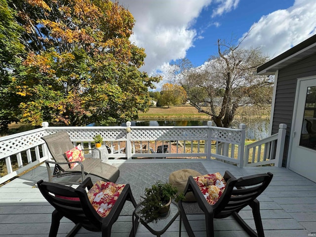 wooden deck featuring a water view