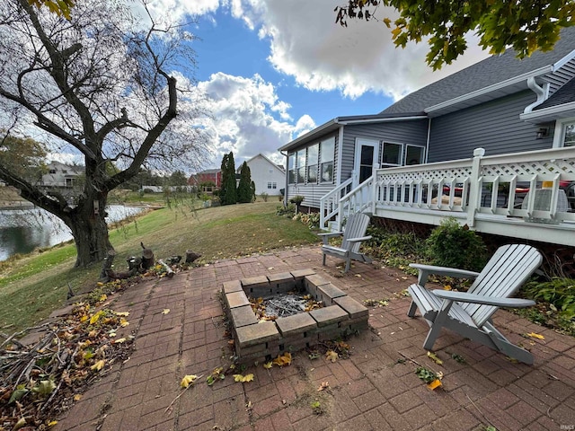 view of patio / terrace featuring an outdoor fire pit and a deck