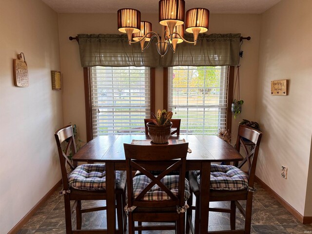 dining space featuring plenty of natural light, a notable chandelier, and a textured ceiling