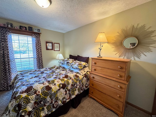 carpeted bedroom featuring a textured ceiling